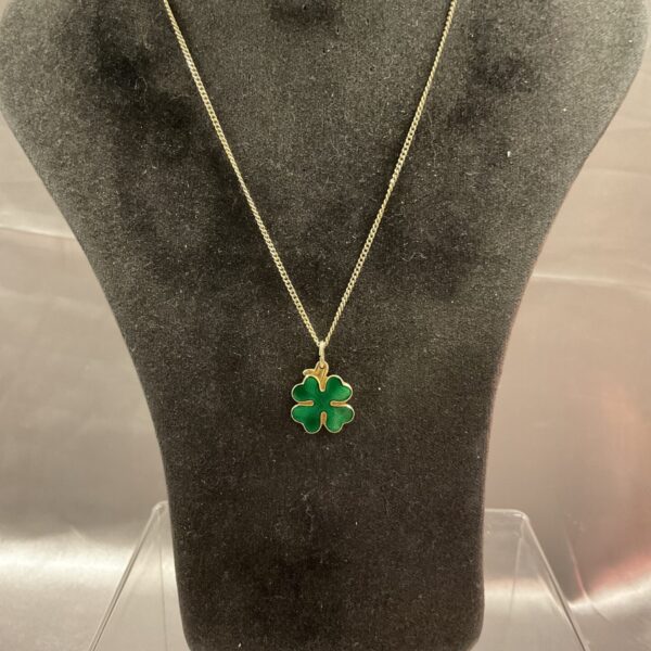 Close-up of David Anderson silver gilt clover necklace on display.