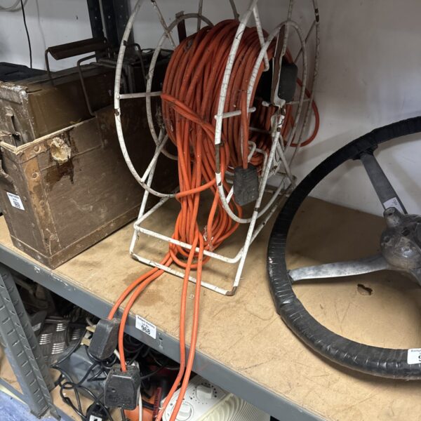 Vintage wire frame extension reel with orange cable.