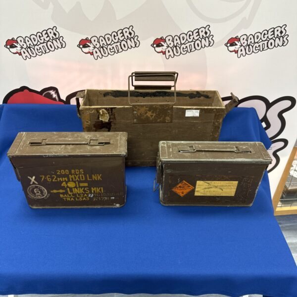 Vintage metal ammo tins and wooden box, military storage collectible.