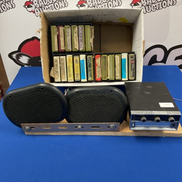 Vintage mini 8 track player with a box of tapes.