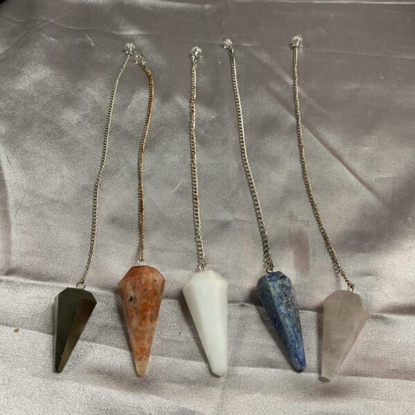 Five crystal pendants with chains, including black obsidian and amethyst.