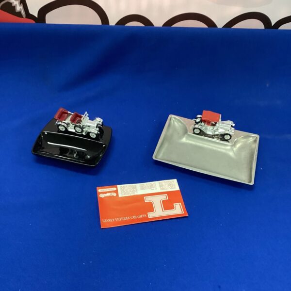 Pair of vintage car ashtrays, collectible automobile decor.