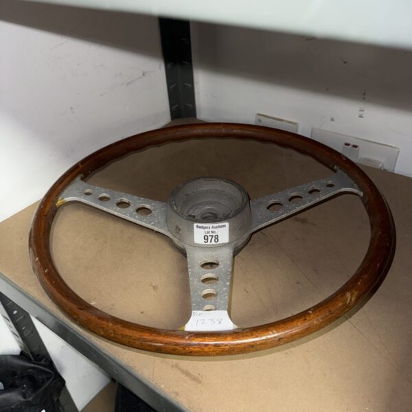 Vintage wooden steering wheel for classic car restoration.