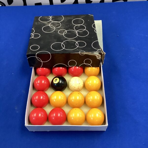 Vintage pool balls set in original box, retro game room collectible.