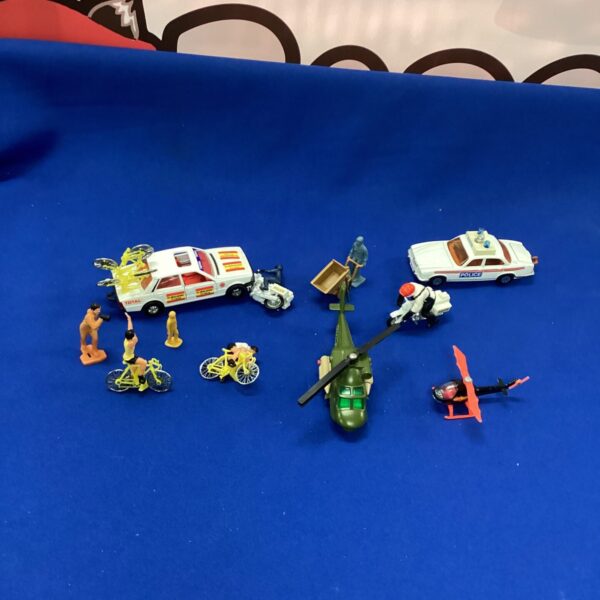 Vintage and modern Matchbox model cars and helicopters in a lot.