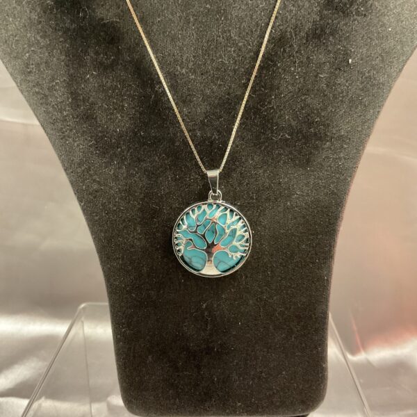 Silver tree of life pendant necklace on a chain.