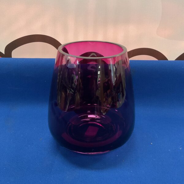 Elegant purple glass vase for home decor and floral displays.
