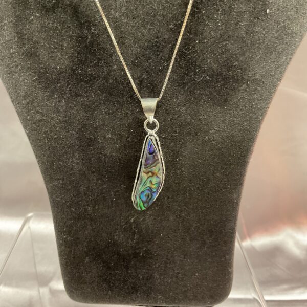 Close-up of silver abalone pendant necklace with iridescent shell.