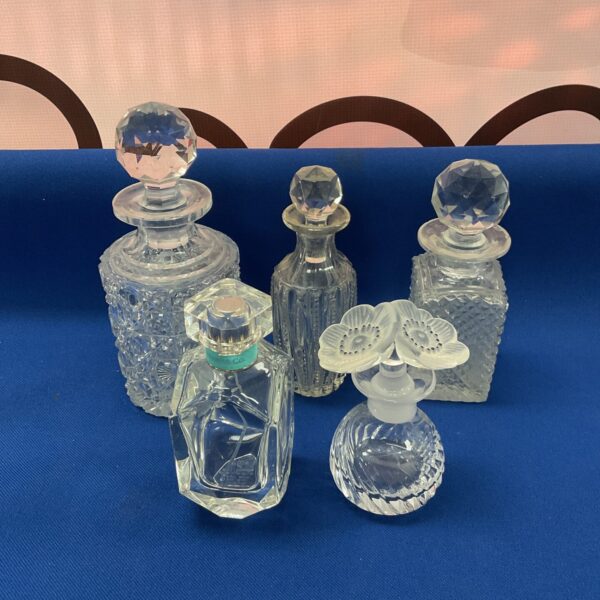 Collection of vintage crystal scent bottles with faceted glass.