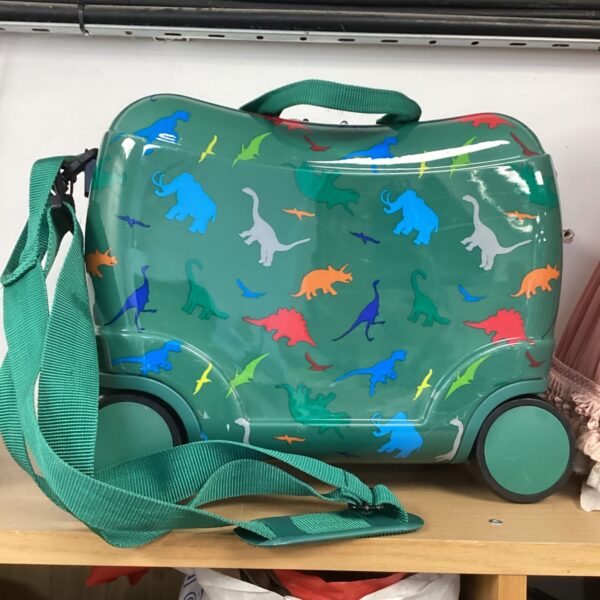 Green child’s wheeled suitcase with a colourful dinosaur print.