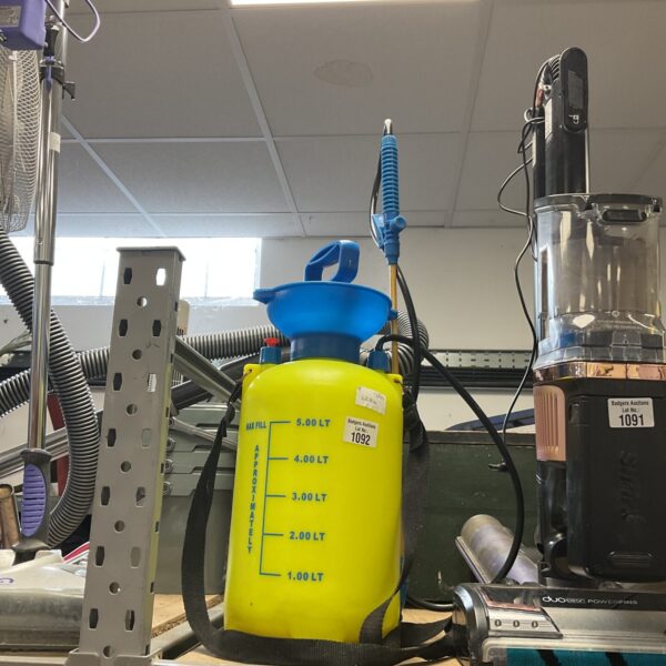 Yellow handheld garden sprayer for plant care and garden use.
