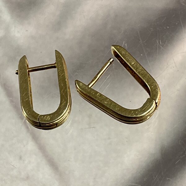 Close-up of a pair of 9ct gold hoop earrings.