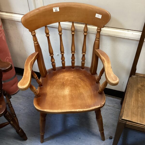 Vintage wooden grandmother armchair with curved arms.