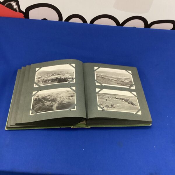 Vintage postcard album cover with aged paper and binding.