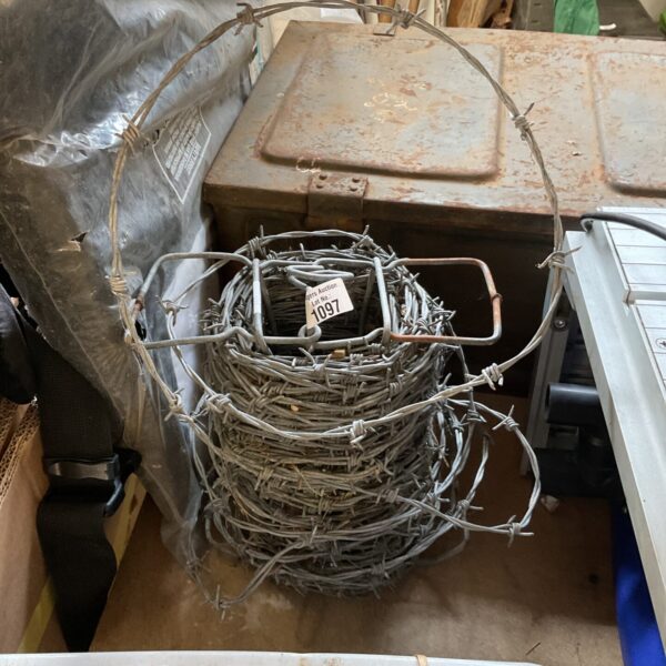 Galvanized steel barbed wire roll for fencing and security.