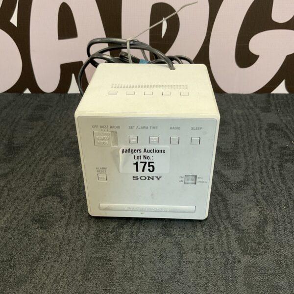 Vintage Sony alarm clock radio on a patterned surface.