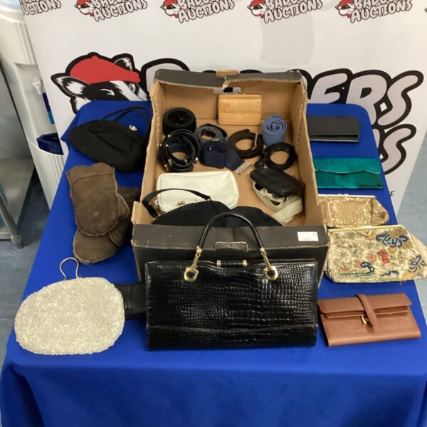 Mixed lot of vintage purses and belts on display.