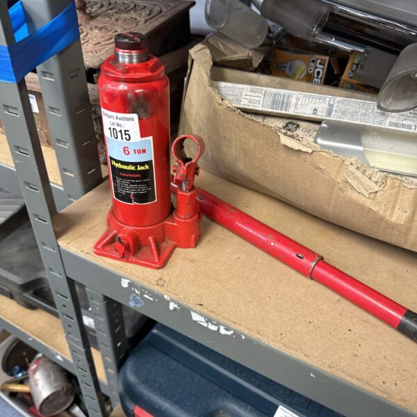 Six-ton hydraulic bottle jack with signs of wear.