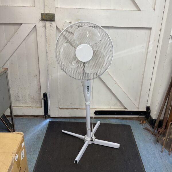 White vintage floor standing electric fan with adjustable head.