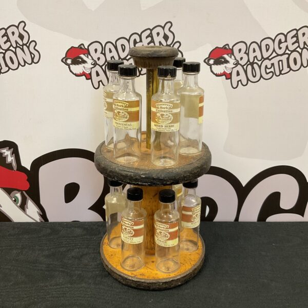 Vintage tiered spice rack with Discovery Herb Collection bottles.