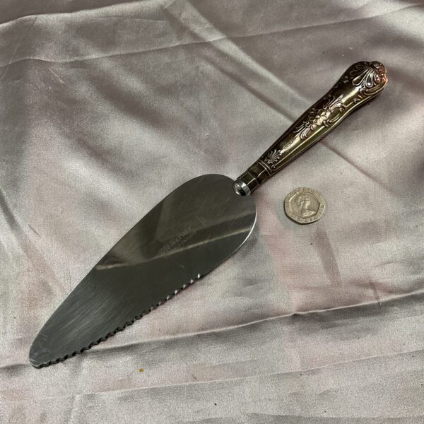 Antique silver cake server with hallmarked blade and ornate handle.