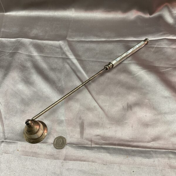 Antique silver candle snuffer with mother-of-pearl inlay.