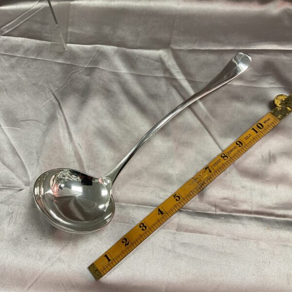 Vintage whitemetal serving ladle, a classic kitchen utensil.