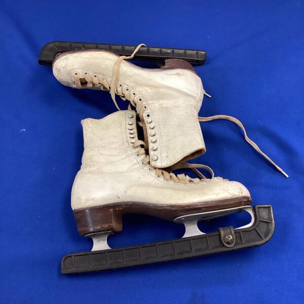 Vintage size 6 ice skates with leather and metal blades.
