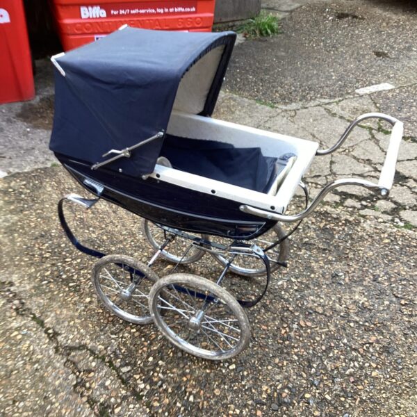 Classic navy blue vintage pram with white wheels.