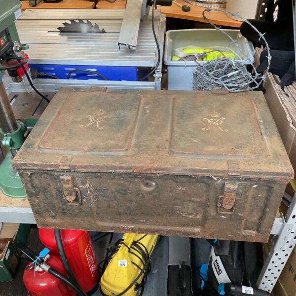 Vintage military ammunition chest with a royal crest embossed on the lid.