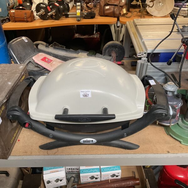 Vintage Weber portable gas BBQ in unrestored condition.