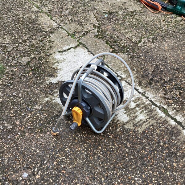 Hozlock garden hose reel with attached hose in outdoor setting.