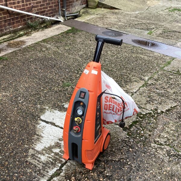Portable Revolution air compressor in used condition for garage or workshop.