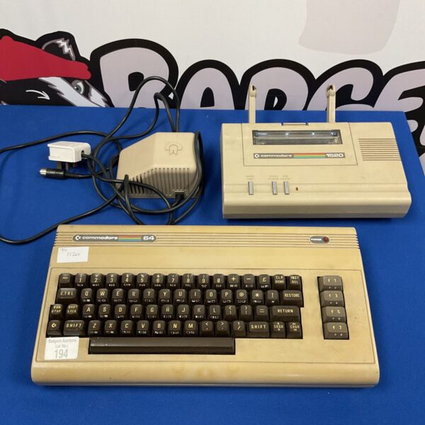 Vintage Commodore 64 console with 1520 printer, retro gaming setup.