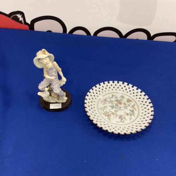 Vintage porcelain plate and figurine set for home decor.