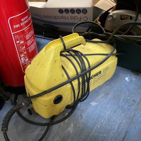 Yellow Karcher 260 pressure washer with lance attachment.