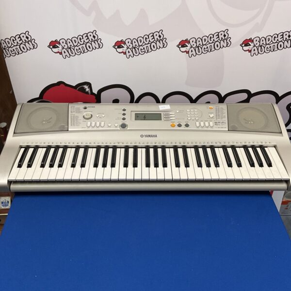 Yamaha PSR E303 keyboard with keys and control panel visible.