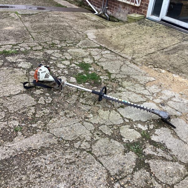 Used Stihl petrol hedge trimmer for garden maintenance.