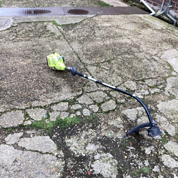 Ryobi petrol strimmer side view, garden landscaping tool.