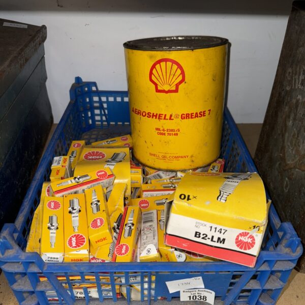Assorted NGK spark plugs and vintage Shell Grease tin.
