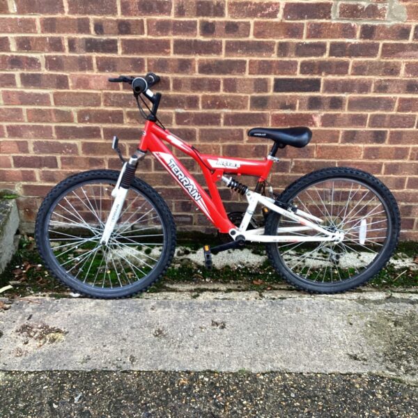Red and silver Atlas Terrain mountain bike for repair.