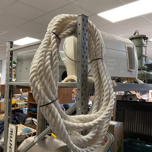 Thick coil of manila rope for nautical or DIY projects.