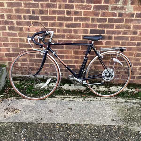 Vintage Raleigh racing bike with steel frame and drop handlebars.