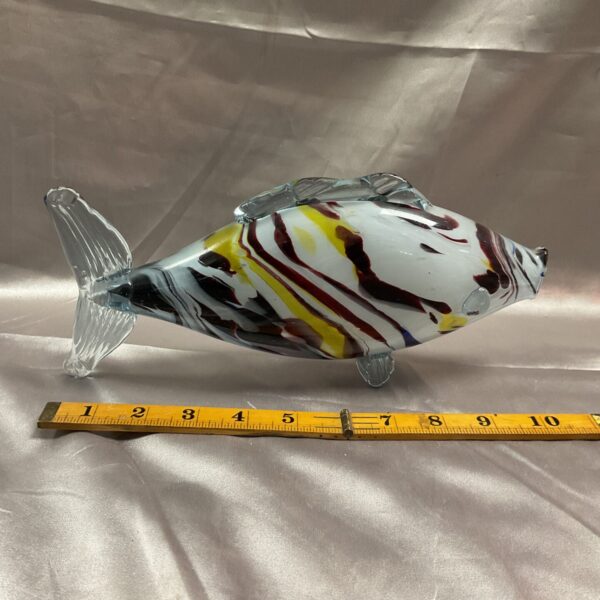 Vibrant Murano glass fish sculpture with swirling colours.