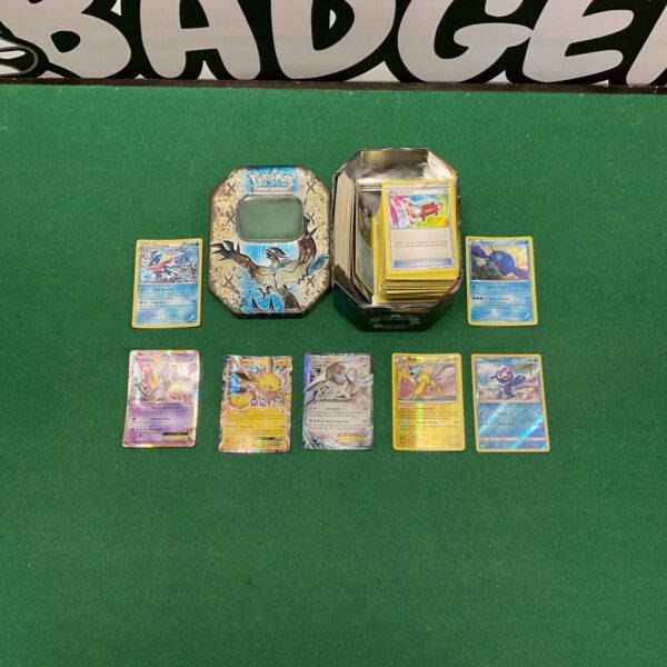 Pokemon trading card tin with cards visible.
