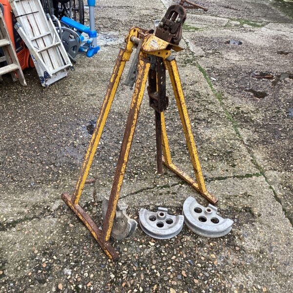 Vintage plumbers pipe bending bench with rollers.