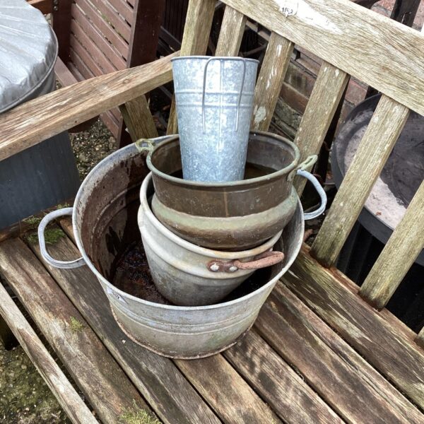 Selection of vintage galvanised tubs in a garden setting.