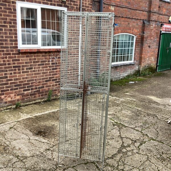 Front view of a tall mesh storage cage.