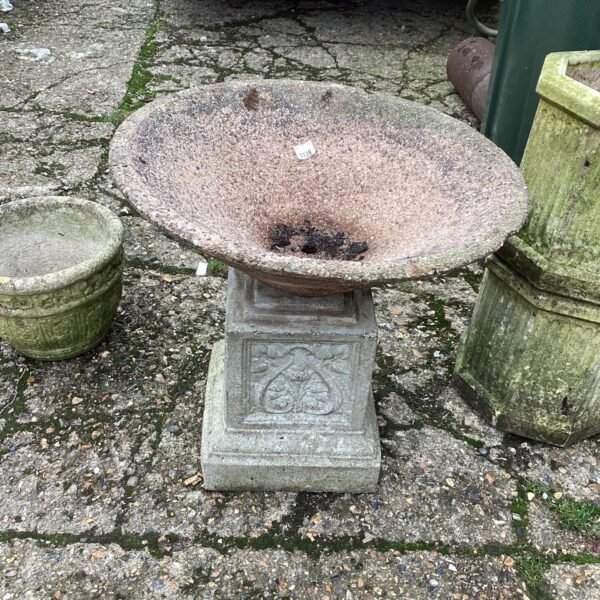 Large grey stone garden planter for outdoor display.