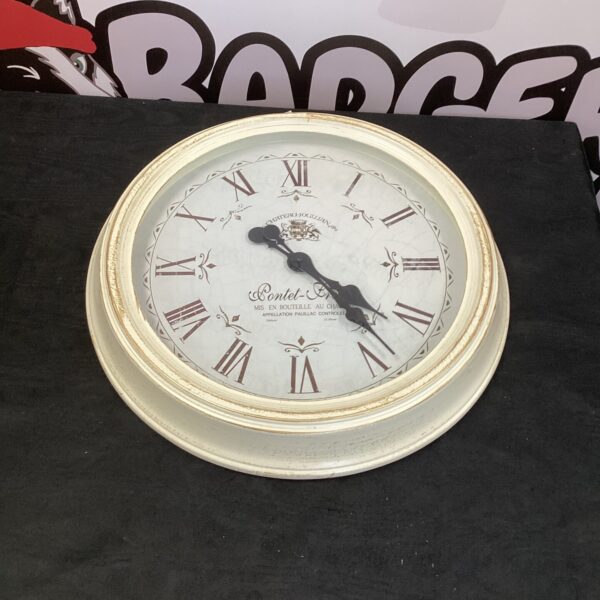 Chateau Jogllian wall clock with Roman numerals, vintage style.